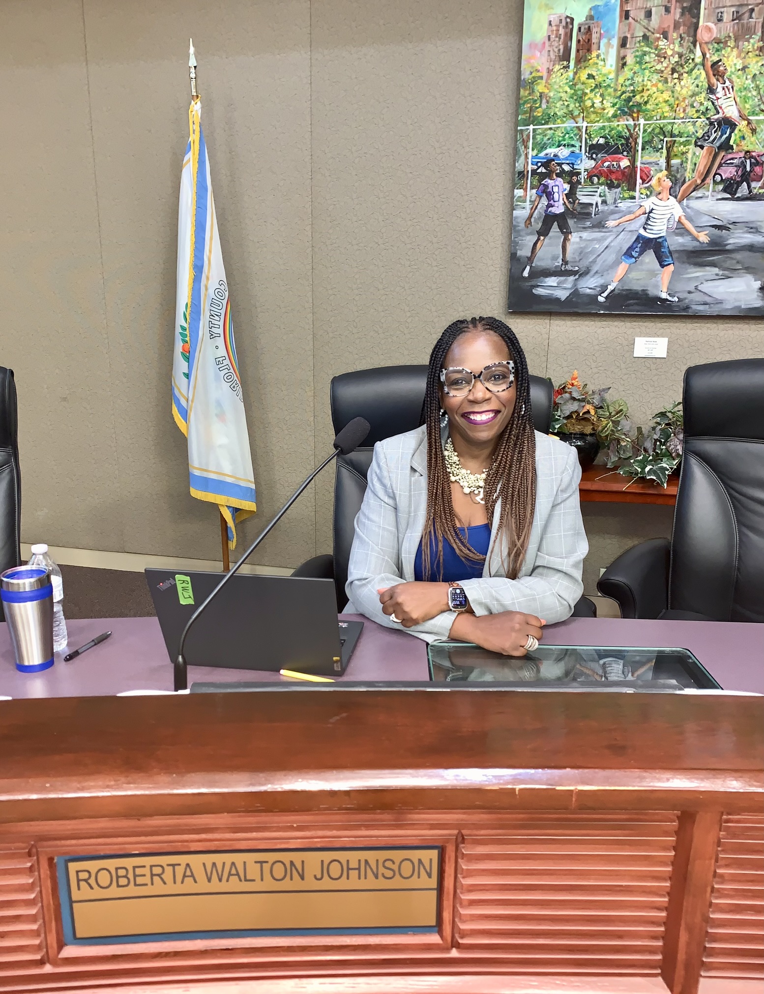 Roberta Walton seated at a council dais with her nameplate visible.